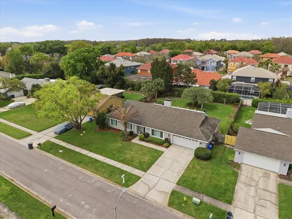 an aerial view of a house with garden space and street view