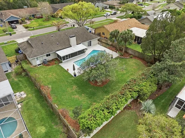an aerial view of residential houses with outdoor space and street view