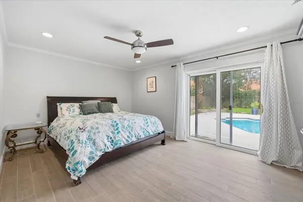 a bedroom with a large bed and a balcony view