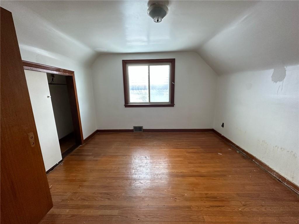 809 St Clair Avenue Clairton, PA 15025 - Photo 12 of 15 an empty room with wooden floor and windows