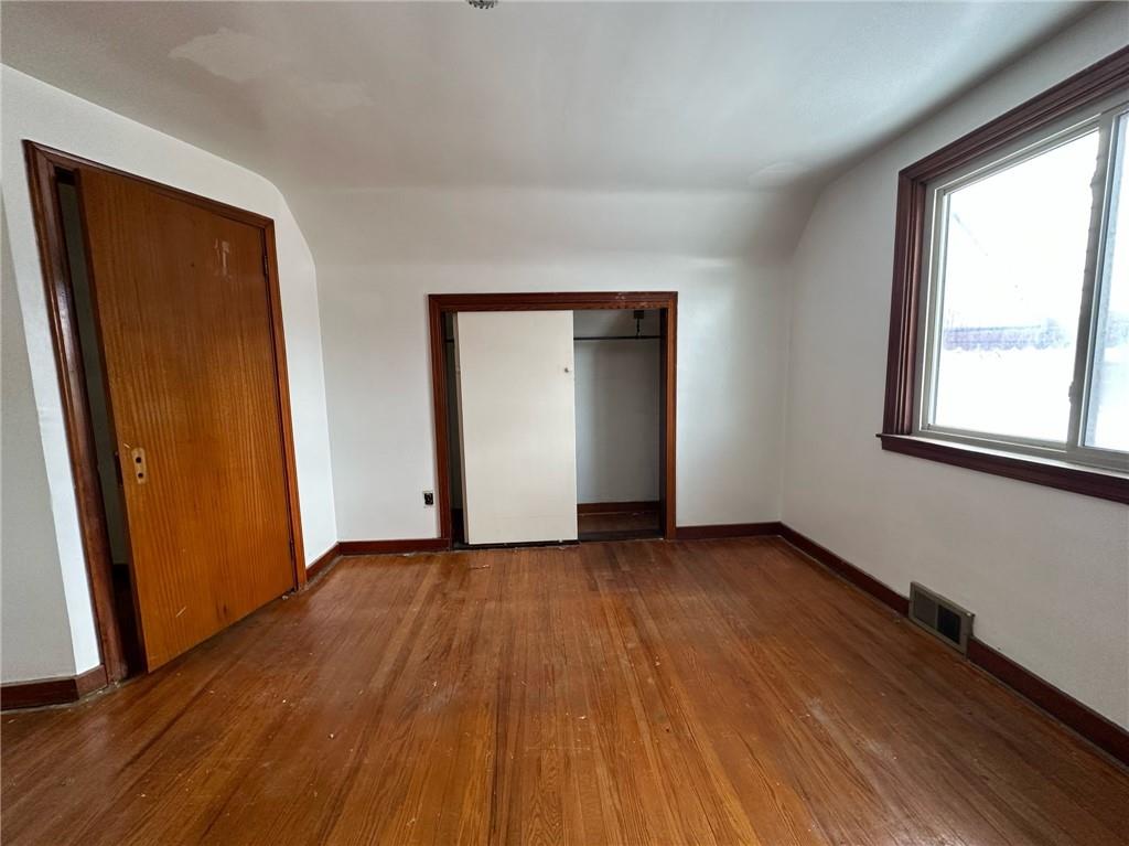 809 St Clair Avenue Clairton, PA 15025 - Photo 13 of 15 an empty room with wooden floor and windows