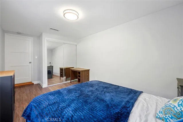 a bedroom with a bed and cabinets