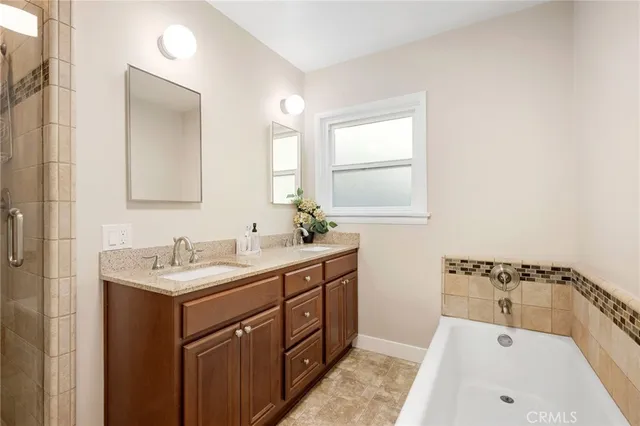 a bathroom with a tub sink and mirror