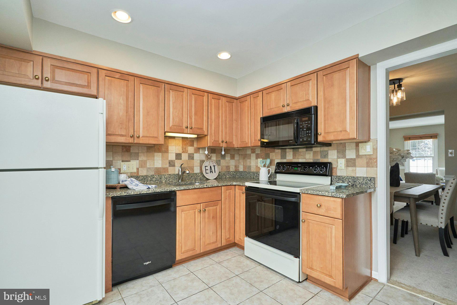9634 Blincoe Court Burke, VA 22015 - Photo 13 of 53 a kitchen with a sink a stove top oven and white stainless steel appliances