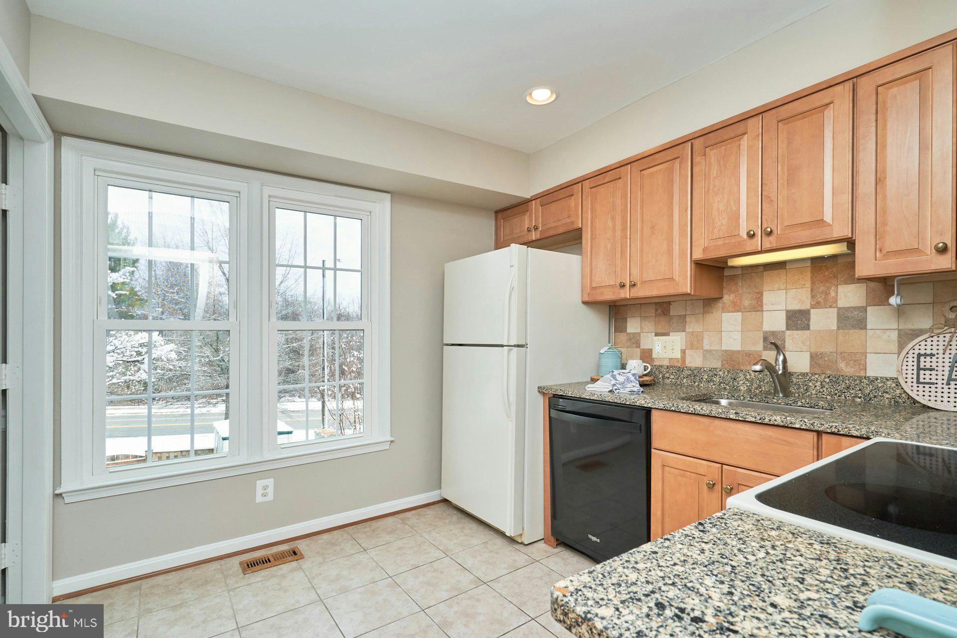 9634 Blincoe Court Burke, VA 22015 - Photo 14 of 53 a kitchen with stainless steel appliances granite countertop a refrigerator sink and stove