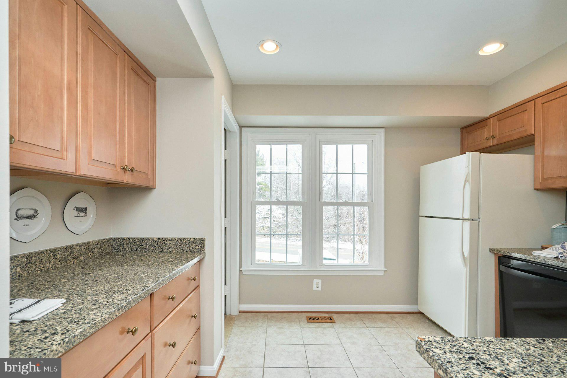 9634 Blincoe Court Burke, VA 22015 - Photo 15 of 53 a kitchen with a refrigerator a stove a sink dishwasher and wooden cabinets