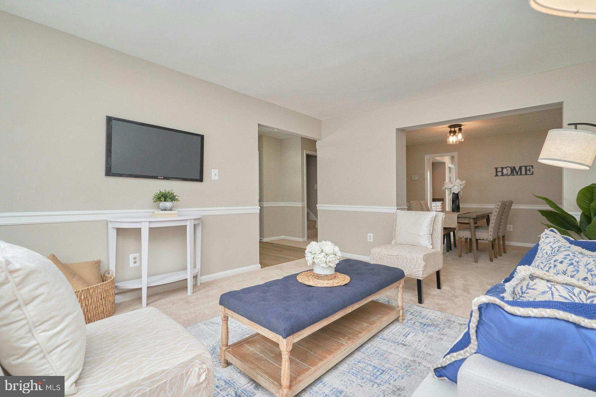 9634 Blincoe Court Burke, VA 22015 - Photo 6 of 53 a living room with furniture a flat screen tv and a dining table