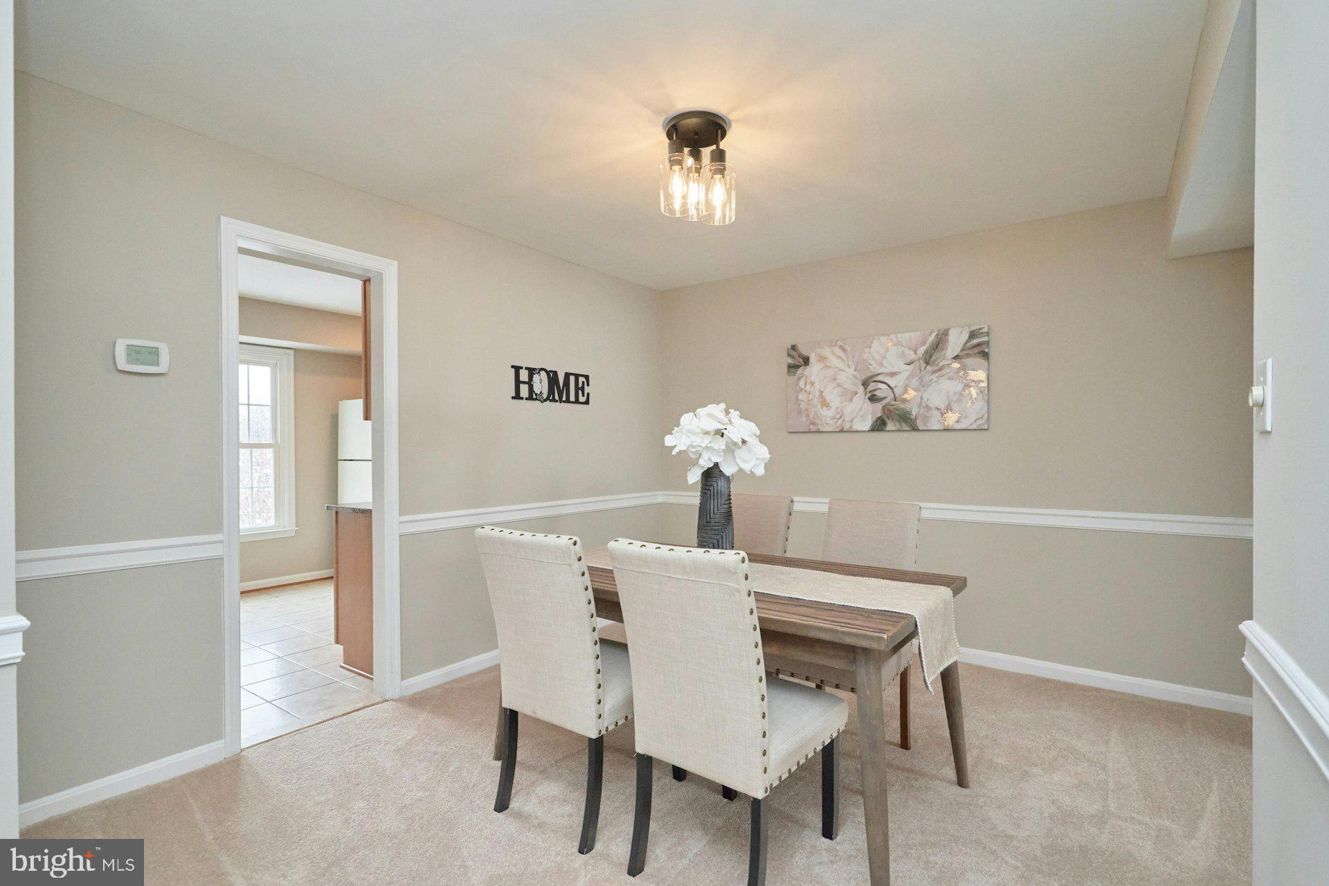 9634 Blincoe Court Burke, VA 22015 - Photo 9 of 53 a view of a dining room with furniture and chandelier