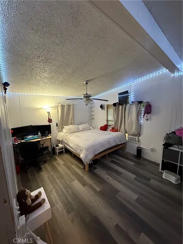 a bedroom with a bed and a chair