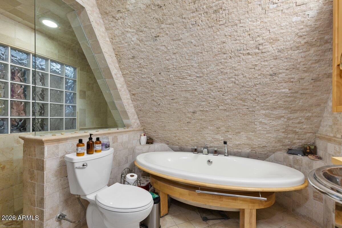 189 Wilson Canyon Road Sedona, AZ 86336 - Photo 20 of 47 a bathroom with a sink a toilet and a mirror