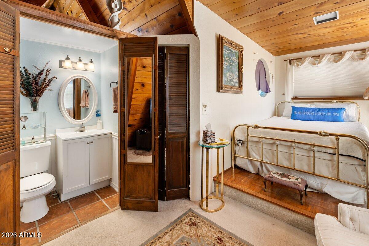 189 Wilson Canyon Road Sedona, AZ 86336 - Photo 23 of 47 a bathroom with a toilet a sink and mirror