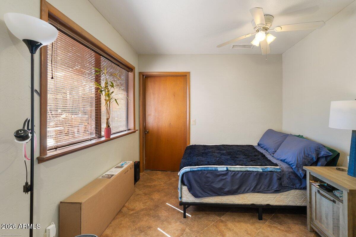 189 Wilson Canyon Road Sedona, AZ 86336 - Photo 26 of 47 a bedroom with a bed and window