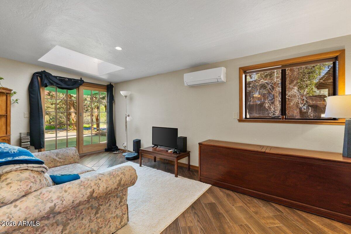 189 Wilson Canyon Road Sedona, AZ 86336 - Photo 28 of 47 a living room with furniture large window and wooden floor