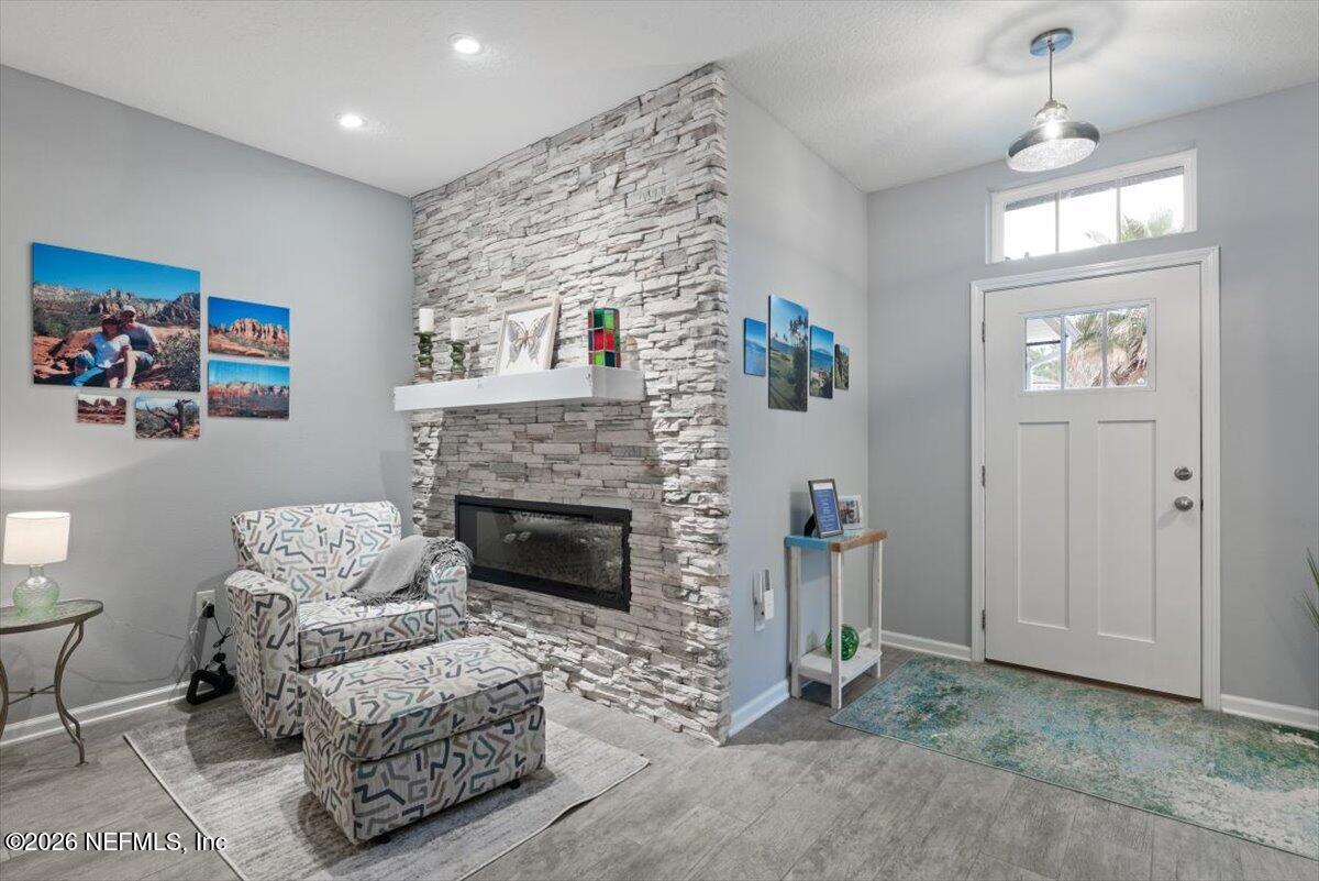 96085 Breezeway Court Yulee, FL 32097 - Photo 11 of 59 a living room with furniture and a fireplace