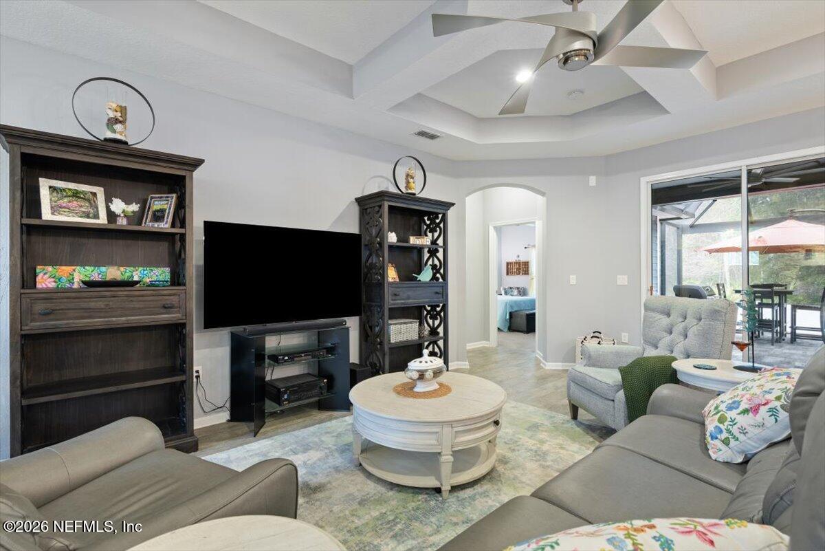 96085 Breezeway Court Yulee, FL 32097 - Photo 14 of 59 a living room with furniture and a flat screen tv