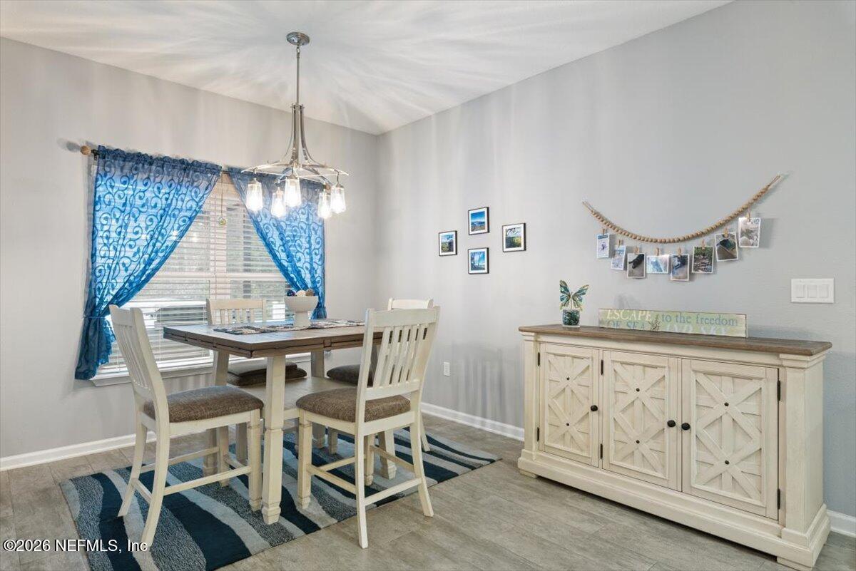 96085 Breezeway Court Yulee, FL 32097 - Photo 20 of 59 a view of a dining room with furniture and wooden floor
