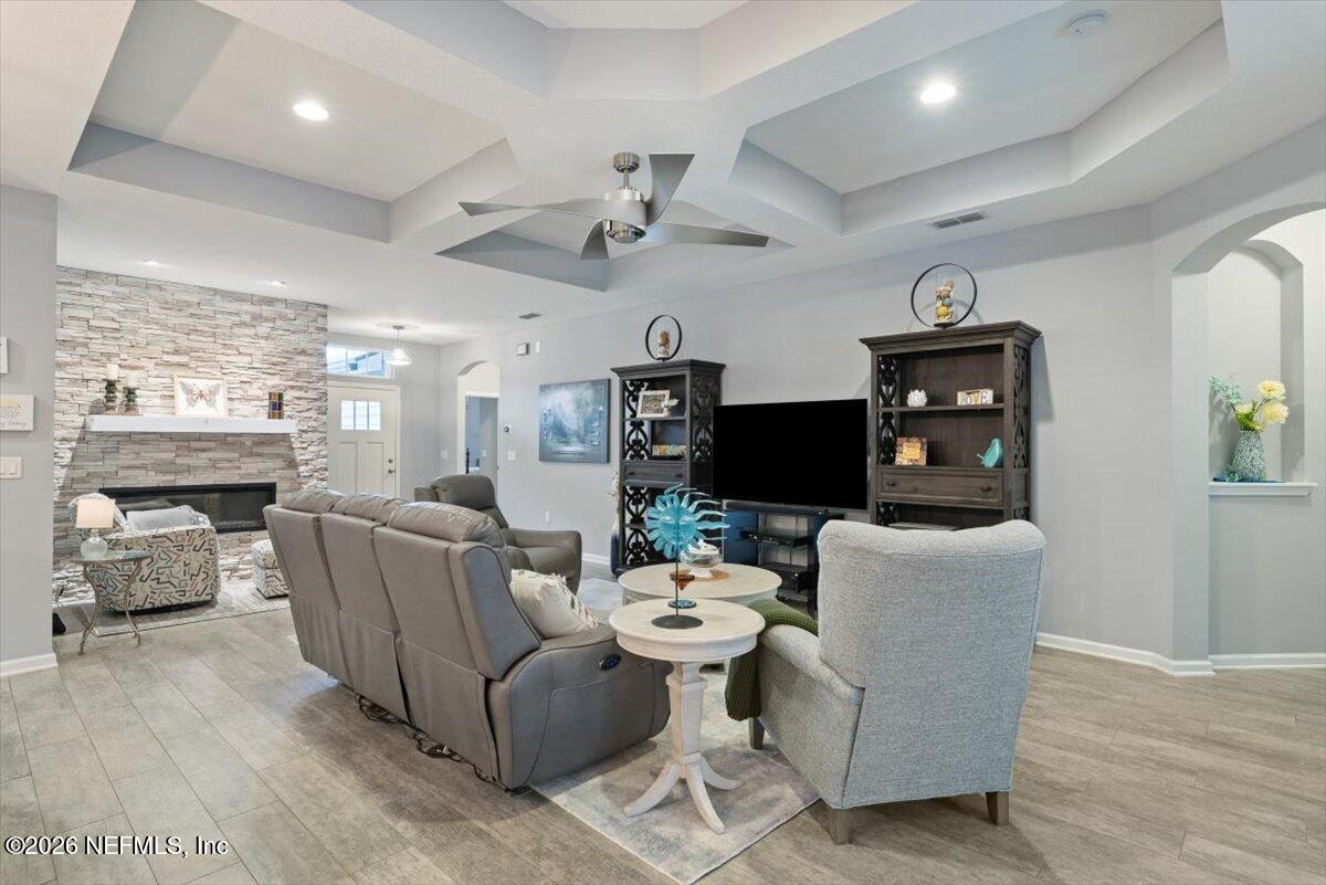 96085 Breezeway Court Yulee, FL 32097 - Photo 2 of 59 a living room with furniture a flat screen tv and a fireplace