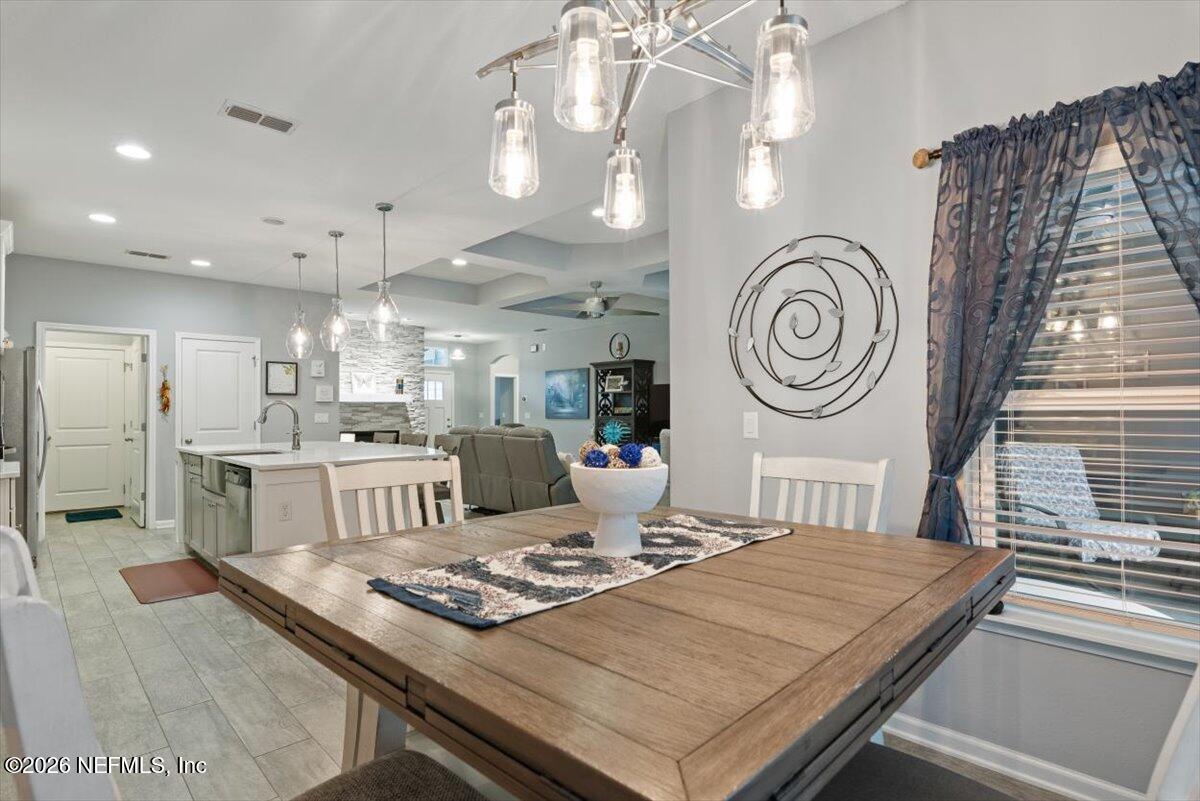 96085 Breezeway Court Yulee, FL 32097 - Photo 21 of 59 a large kitchen with a table and a clock