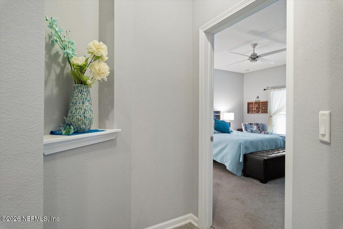 96085 Breezeway Court Yulee, FL 32097 - Photo 22 of 59 a living room with furniture and a chandelier