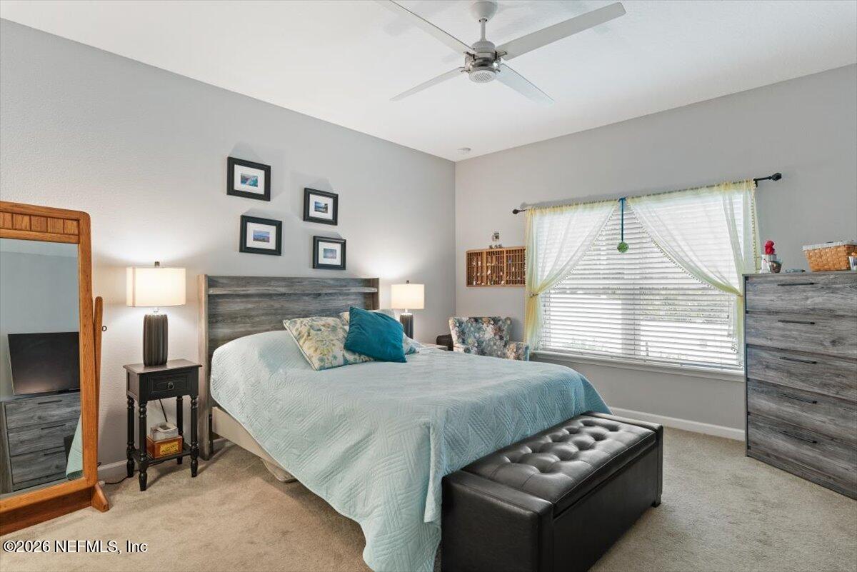 96085 Breezeway Court Yulee, FL 32097 - Photo 23 of 59 a bedroom with a bed and a couch