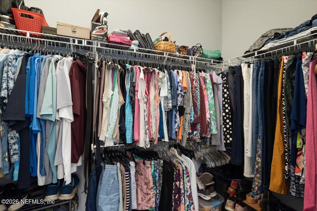 96085 Breezeway Court Yulee, FL 32097 - Photo 26 of 59 a view of walk in closet with clothes