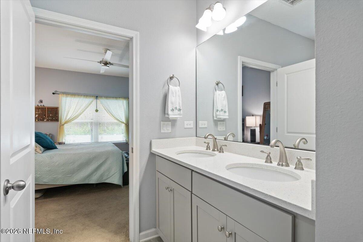 96085 Breezeway Court Yulee, FL 32097 - Photo 28 of 59 a en suite bathroom with a double vanity sink and a mirror