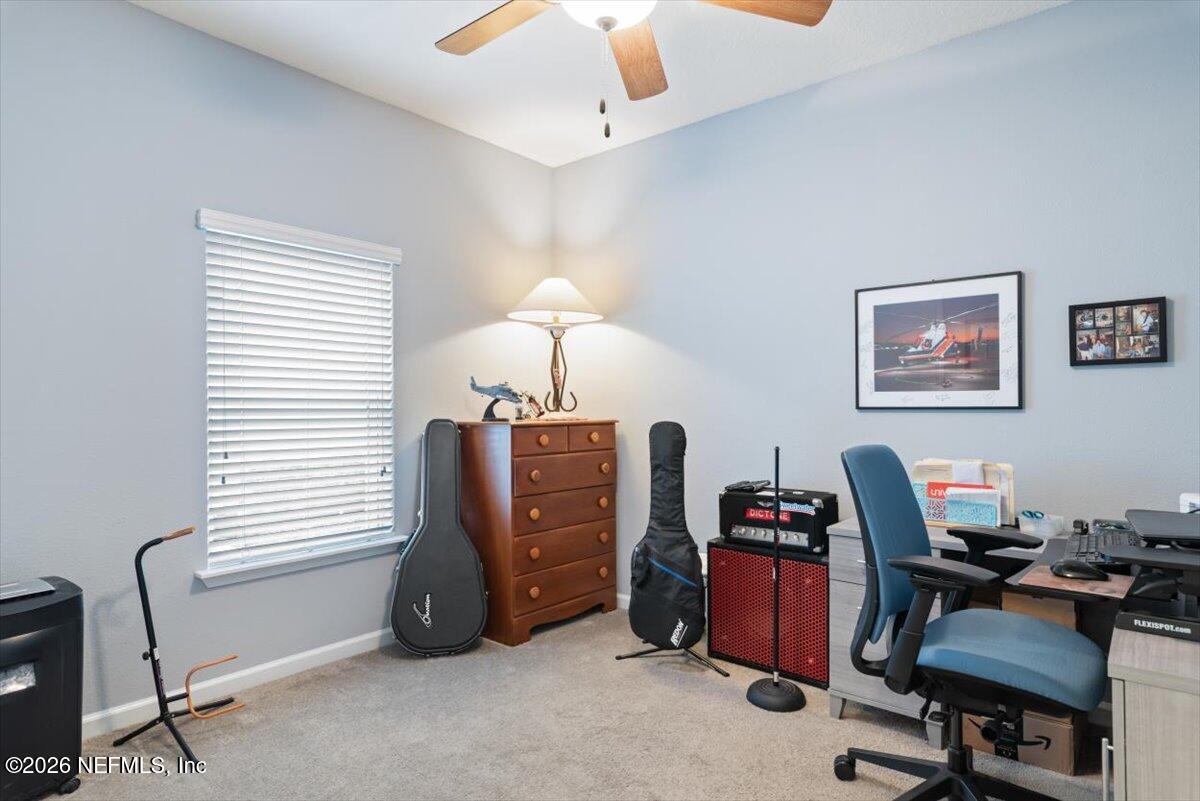 96085 Breezeway Court Yulee, FL 32097 - Photo 32 of 59 a view of a workspace with furniture and a window