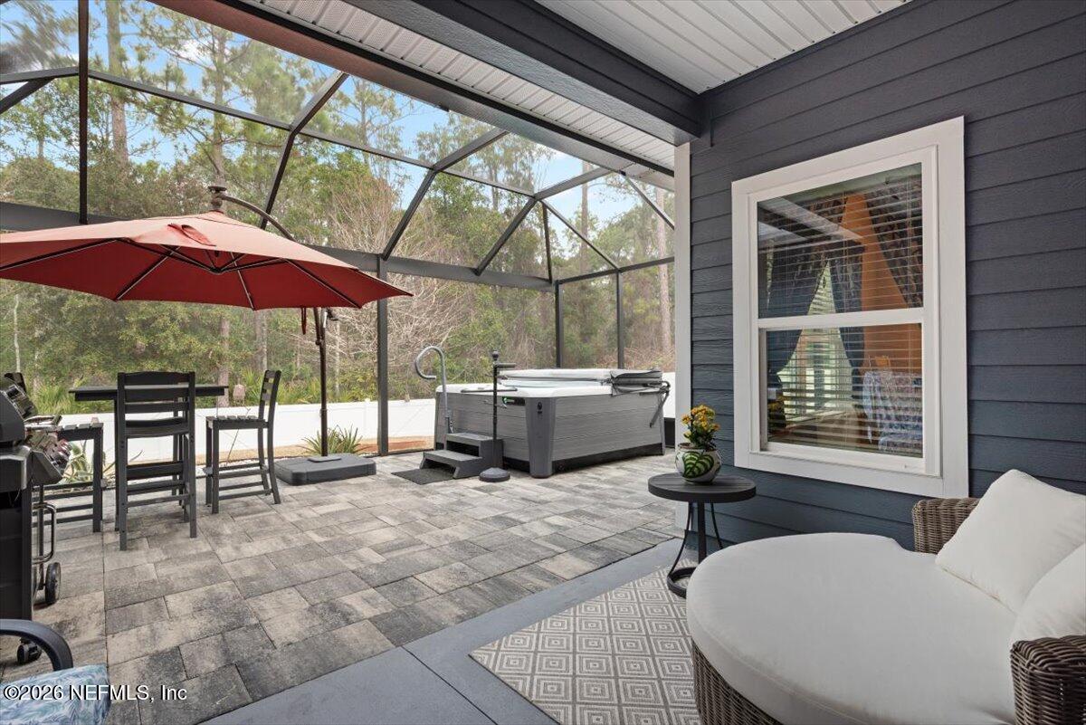 96085 Breezeway Court Yulee, FL 32097 - Photo 38 of 59 a view of a patio with a table and chairs under an umbrella