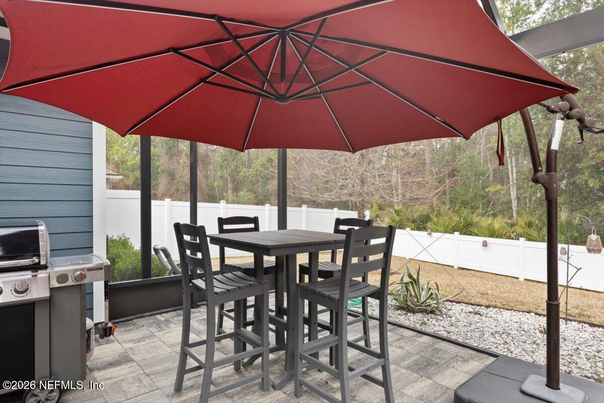 96085 Breezeway Court Yulee, FL 32097 - Photo 41 of 59 a view of an outdoor space with furniture and umbrella