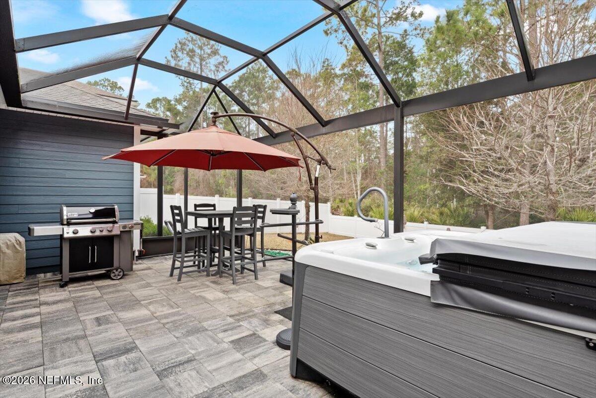 96085 Breezeway Court Yulee, FL 32097 - Photo 43 of 59 a outdoor space with patio lots of white furniture and umbrella