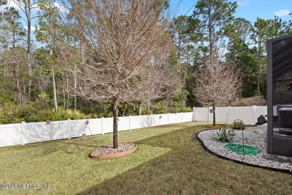 96085 Breezeway Court Yulee, FL 32097 - Photo 47 of 59 a view of a bench in the middle of a yard