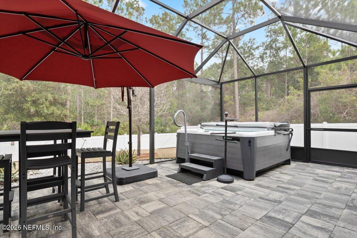 96085 Breezeway Court Yulee, FL 32097 - Photo 5 of 59 a view of a patio with a table and chairs under an umbrella