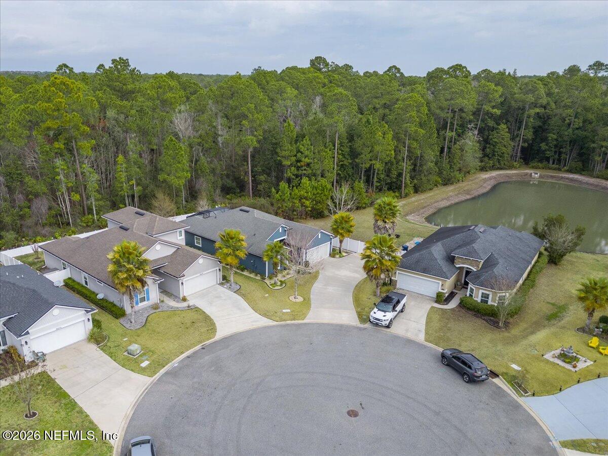 96085 Breezeway Court Yulee, FL 32097 - Photo 54 of 59 an aerial view of a house with garden space and lake view