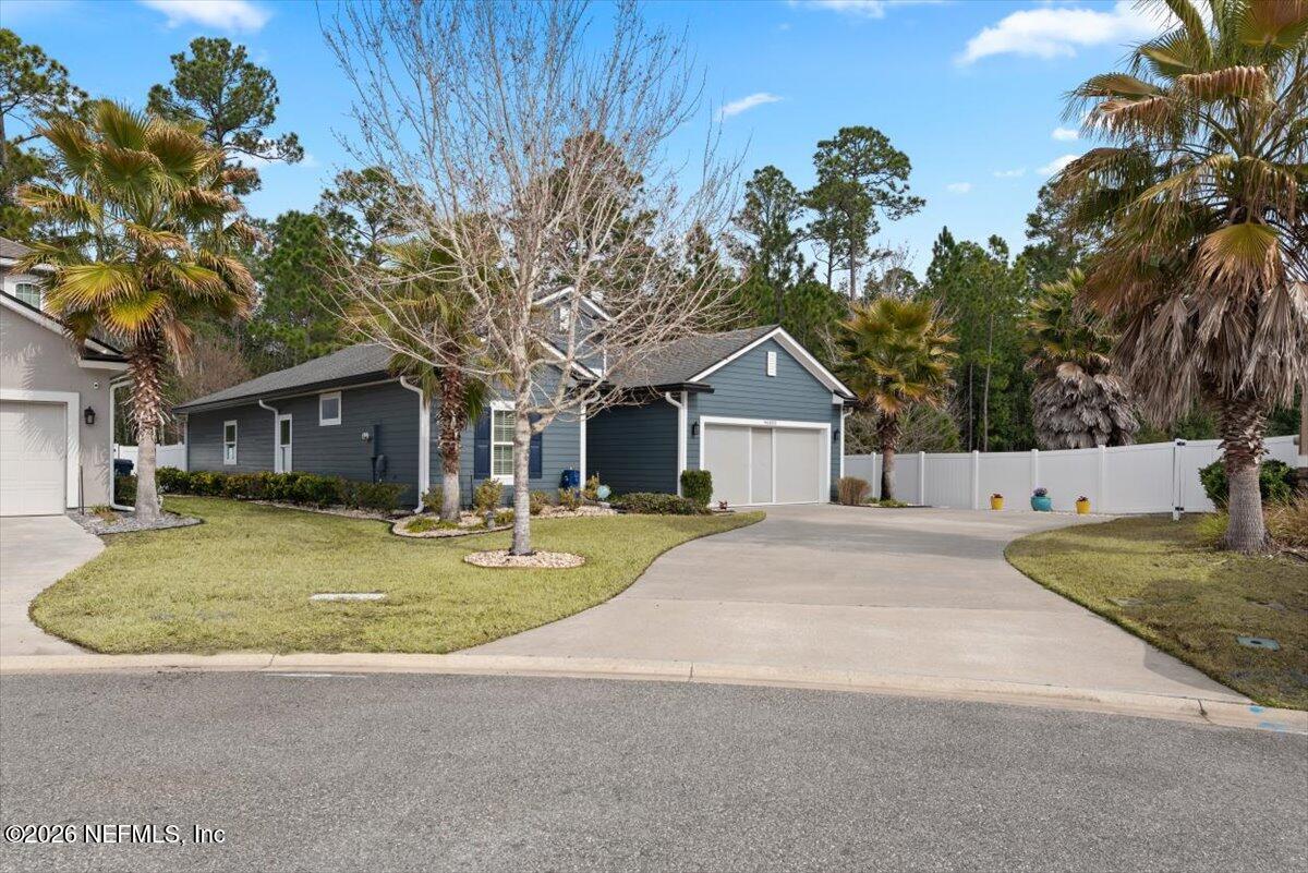 96085 Breezeway Court Yulee, FL 32097 - Photo 7 of 59 a front view of a house with garden