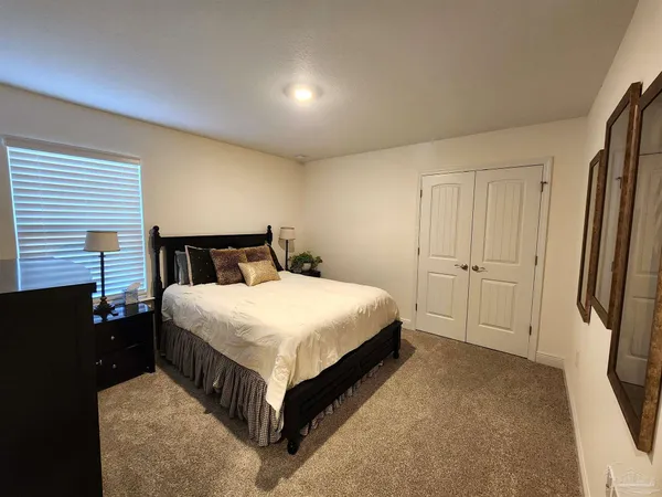 a bedroom with a bed and a dresser