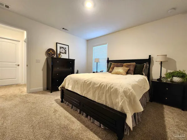 a bedroom with a bed and lamp