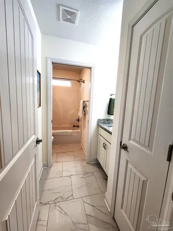 a kitchen with white cabinets and white appliances