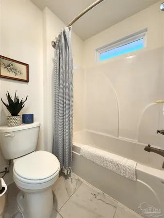 a bathroom with a toilet and a bathtub