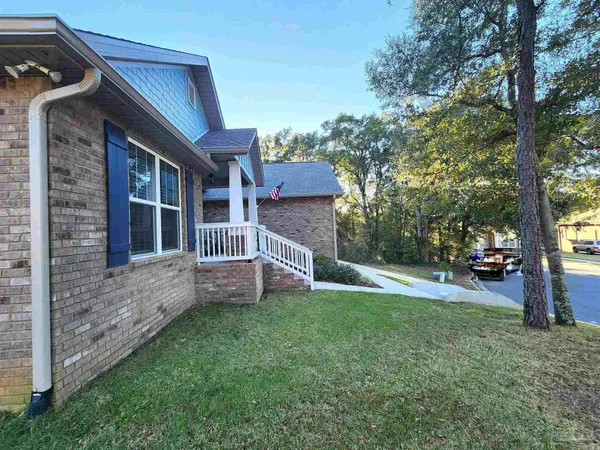a view of a house with a yard and sitting area