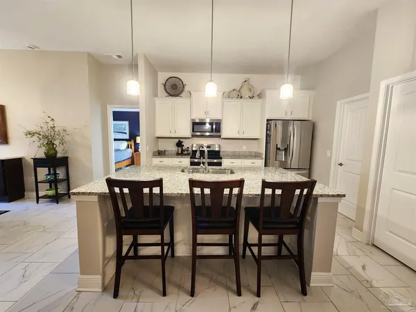 a large kitchen with a table and chairs