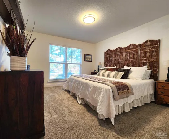 a spacious bedroom with a bed and a window