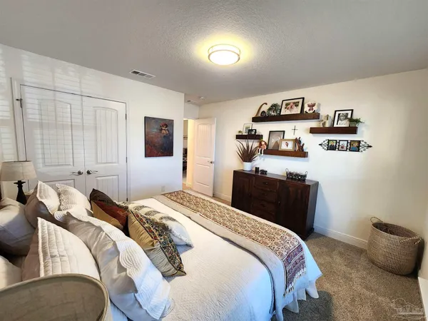 a bedroom with a bed and a tv