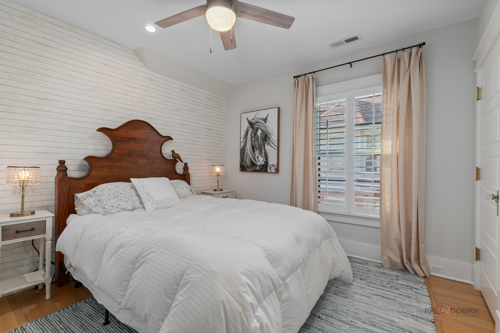 90 East Woodland Road Lake Forest, IL 60045 - Photo 24 of 40 a large bed sitting in a bedroom next to a window and a chandelier