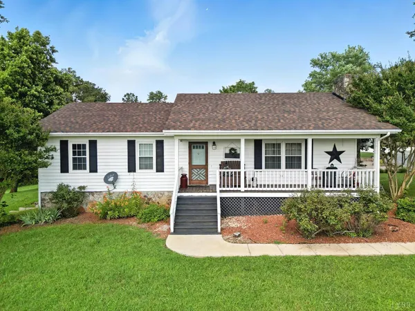 a front view of a house with a yard and porch