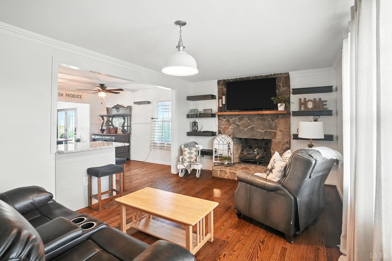 1348 Salem Road Spout Spring, VA 24593 - Photo 26 of 89 a living room with furniture a flat screen tv and a fireplace