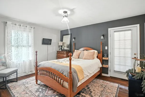 a kitchen that has a lot of white cabinets and stainless steel appliances