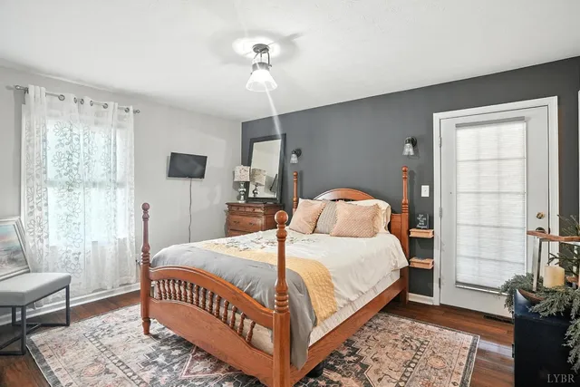 a kitchen that has a lot of white cabinets and stainless steel appliances