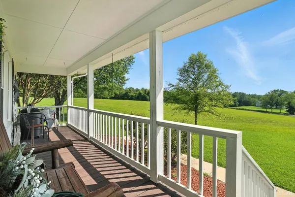 a view of balcony with wooden floor and outdoor seating