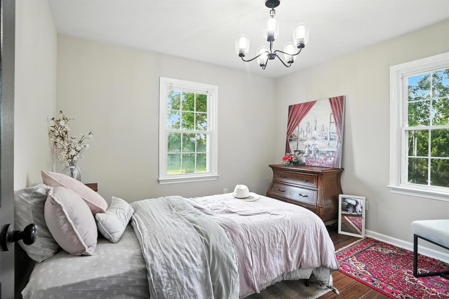 1348 Salem Road Spout Spring, VA 24593 - Photo 32 of 89 a bedroom with a bed and a chandelier