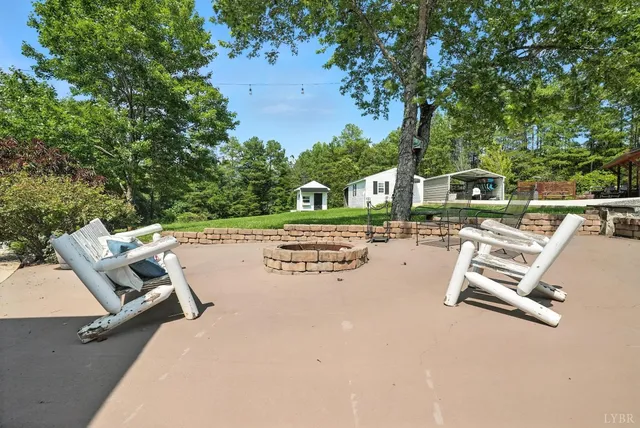 a view of a patio with table and chairs and floor to ceiling window